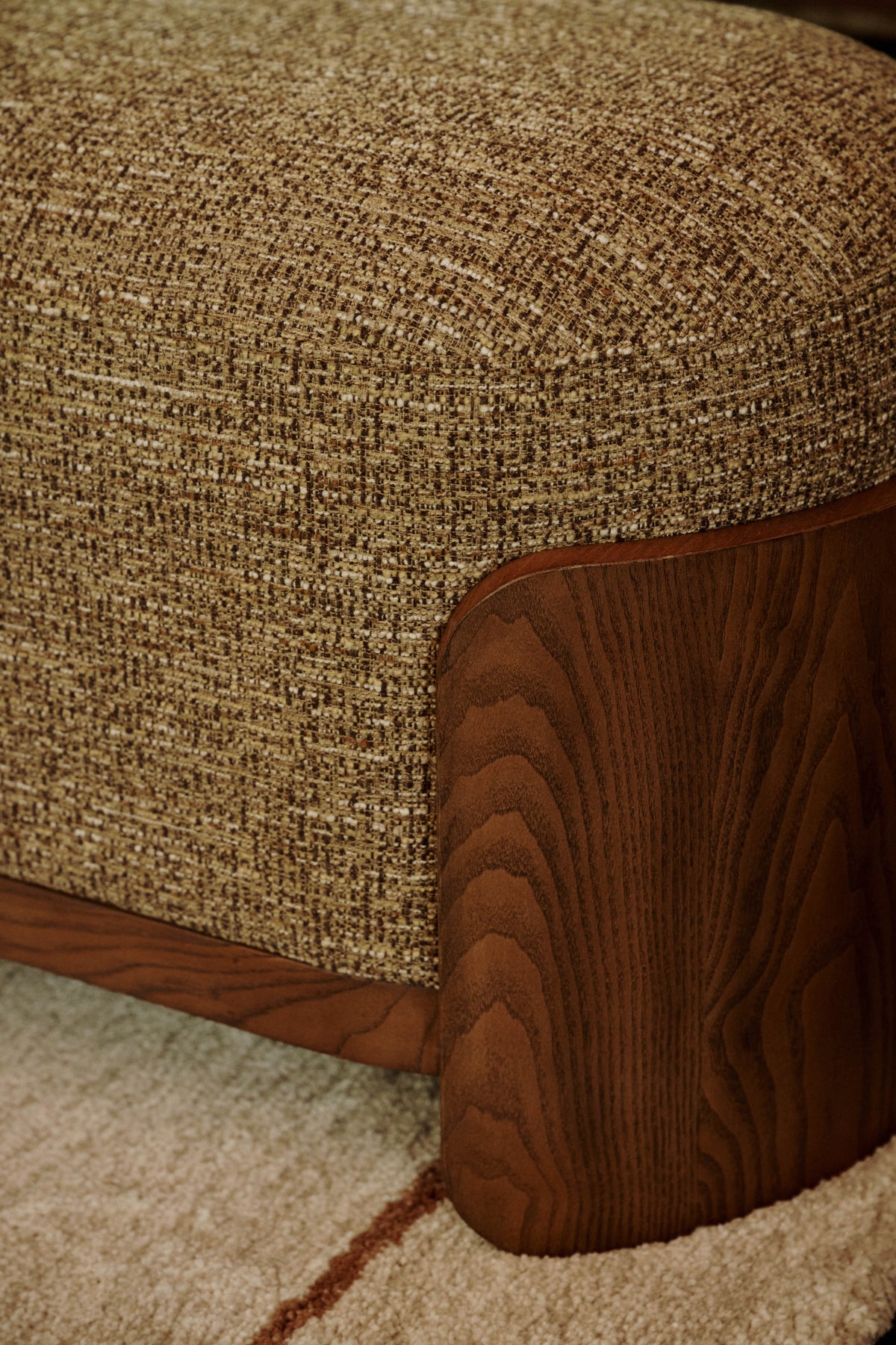 pouf Elipse - gros plan sur le tissu chiné ocre et le veinage de la joue en bois
